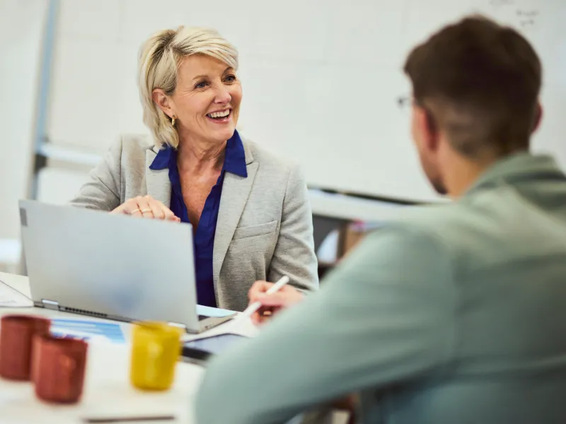 Business manager using laptop on meeting table